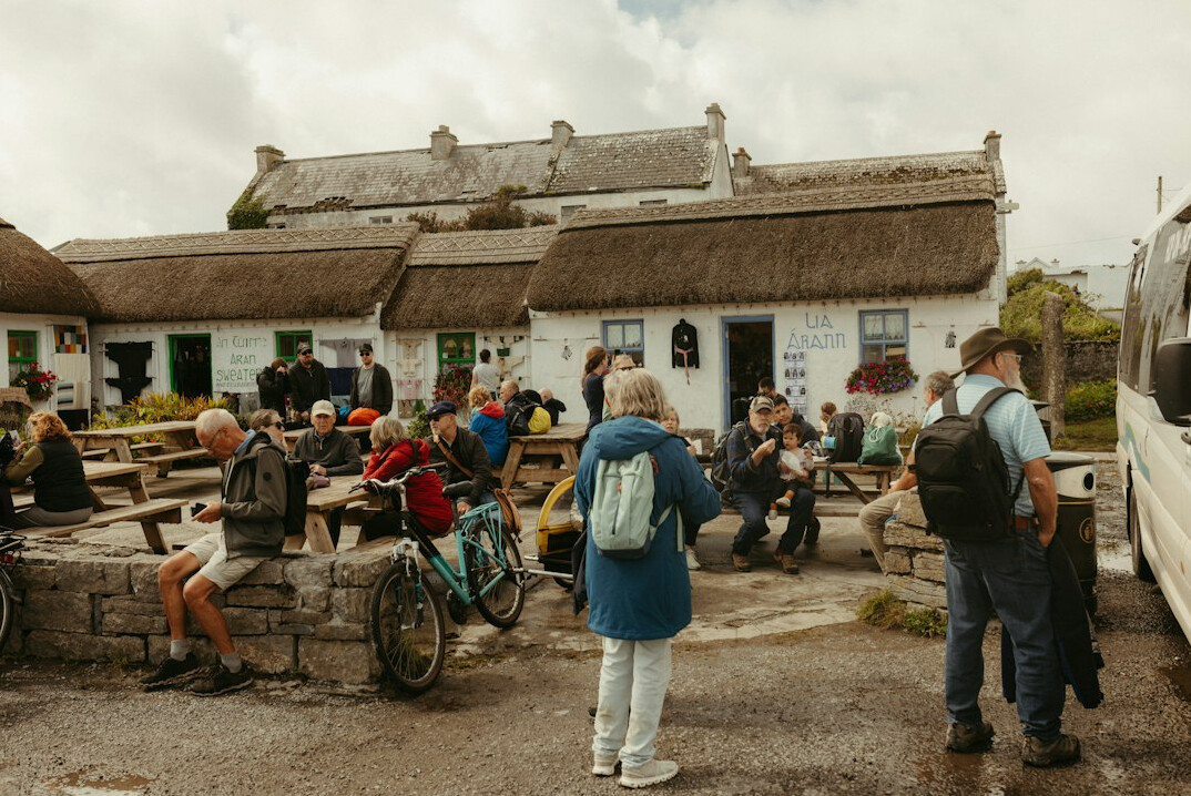 Danish community members of mixed ages gathered talking at a local town hall meeting